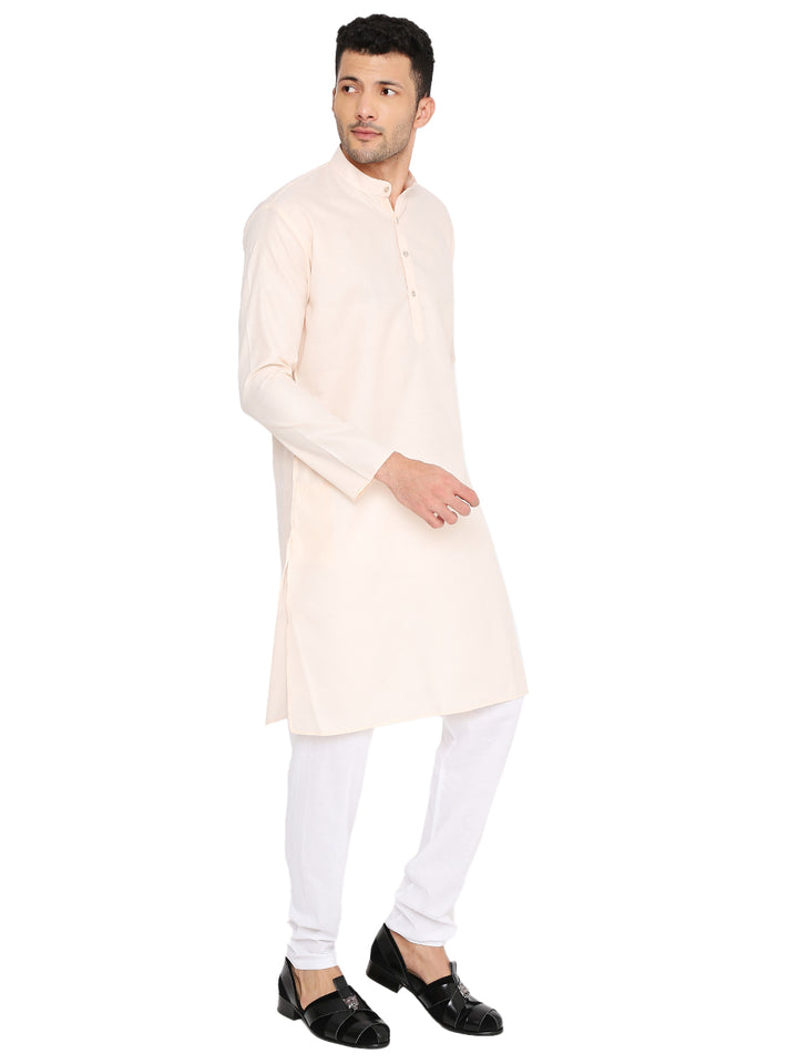 Angled front view of Magic Cotton Peach Kurta for men, styled with white churidar, suitable for casual and ceremonial occasions.