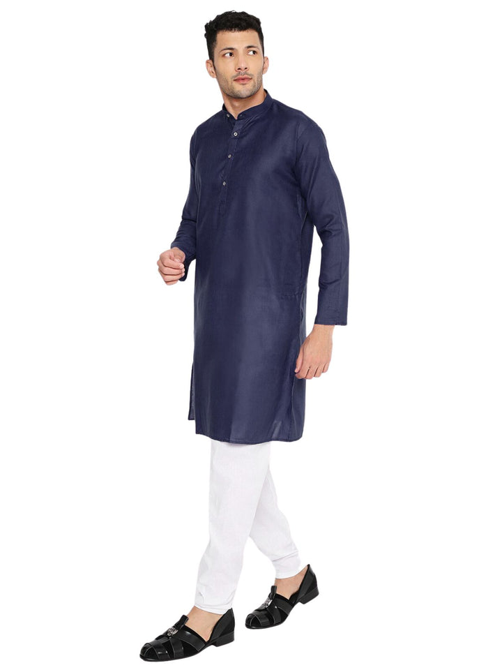 Dark blue kurta set styled with white pajama, featuring a modern yet traditional look suitable for festive and daily wear.