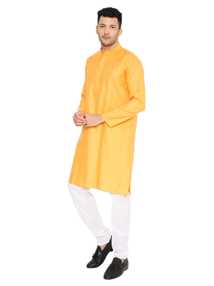 Side pose of Magic Cotton Kurta - Marigold styled with white bottoms. Perfect for ceremonies and casual ethnic dressing.