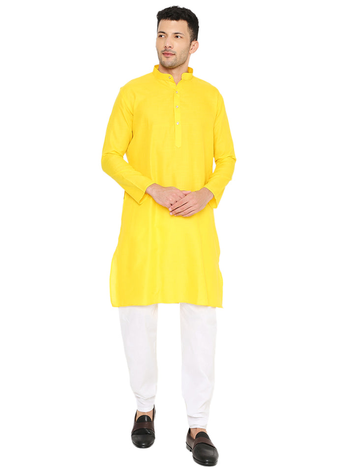 Solid yellow kurta in magic cotton with mandarin collar and button placket, styled with white pajama for a traditional yet modern look.