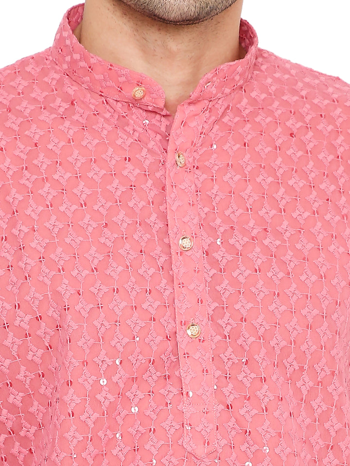 Close-up of pink georgette kurta fabric showing intricate sequin embroidery and gold buttons, ideal for festive Indian attire.