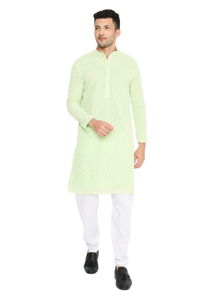 Mint green georgette kurta with sequin embroidery for men, styled with white churidar and black shoes. Ideal festive wear for weddings and parties.