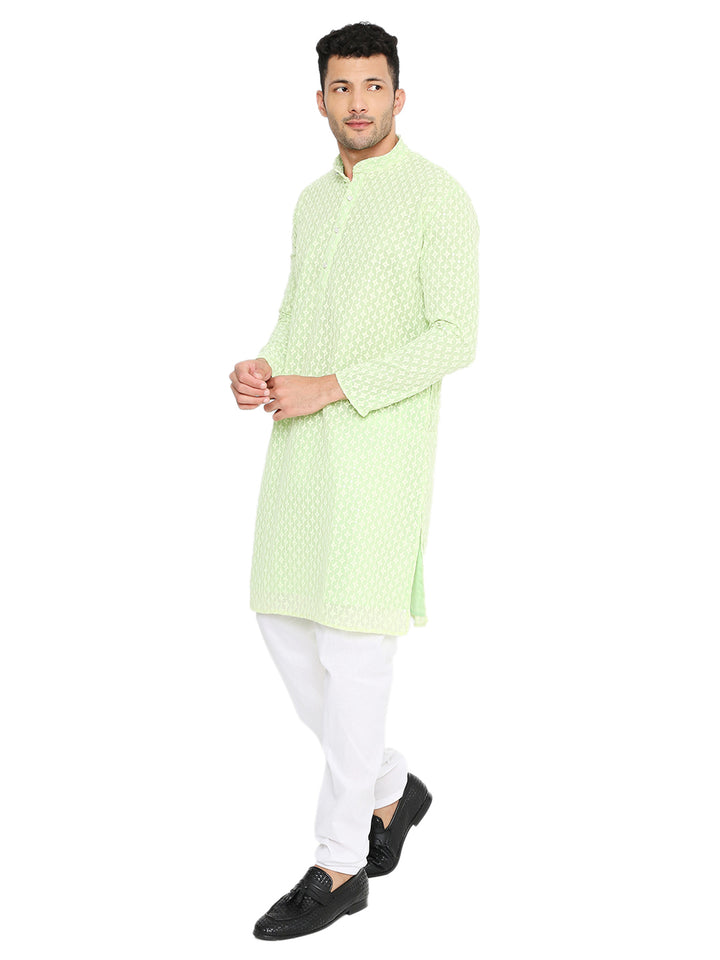 Side pose of man wearing mint green sequin embroidered georgette kurta, perfect for ethnic celebrations and festive gatherings.