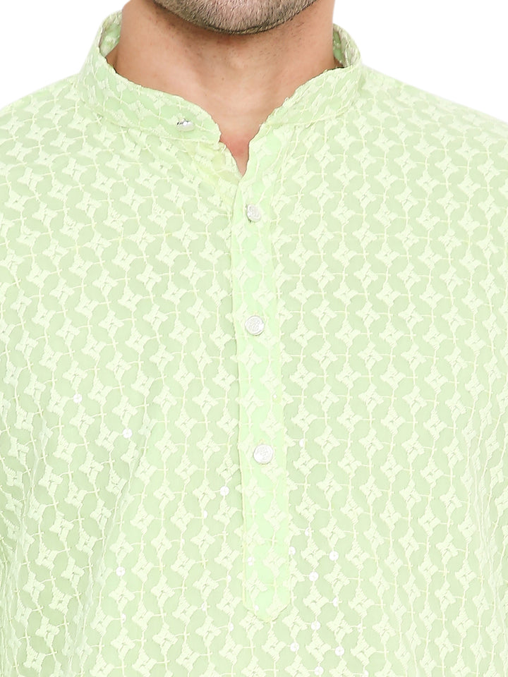 Close-up of mint green georgette kurta neckline with sequin embroidery and button placket, highlighting intricate festive detailing.