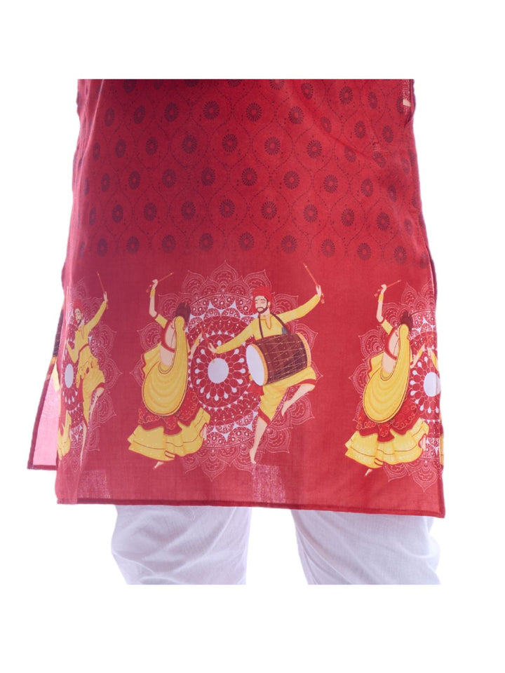 Close-up of red kurta hem with yellow dancers and drum print, highlighting the intricate Navratri-themed design in cotton fabric.