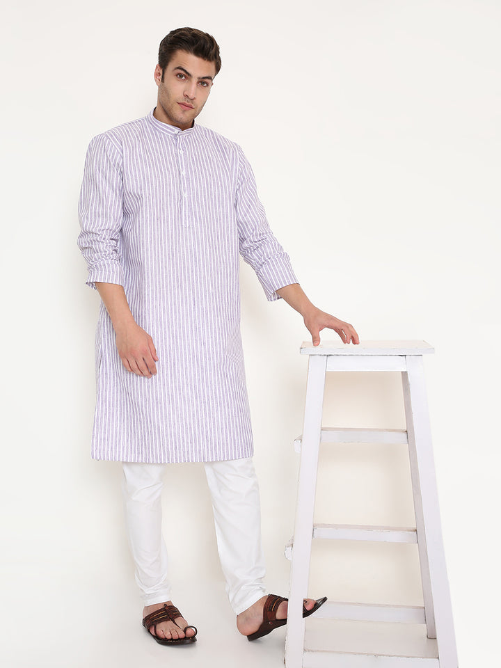 Model wearing Regular Fit Purple Striped Kurta with white churidar, styled casually with sandals, perfect for festive or semi-formal wear.