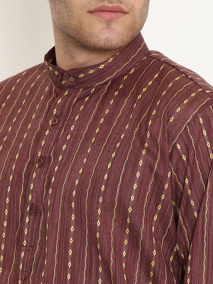 Close-up of maroon ethnic kurta fabric showing intricate golden vertical patterns and mandarin collar, emphasizing texture and craftsmanship.