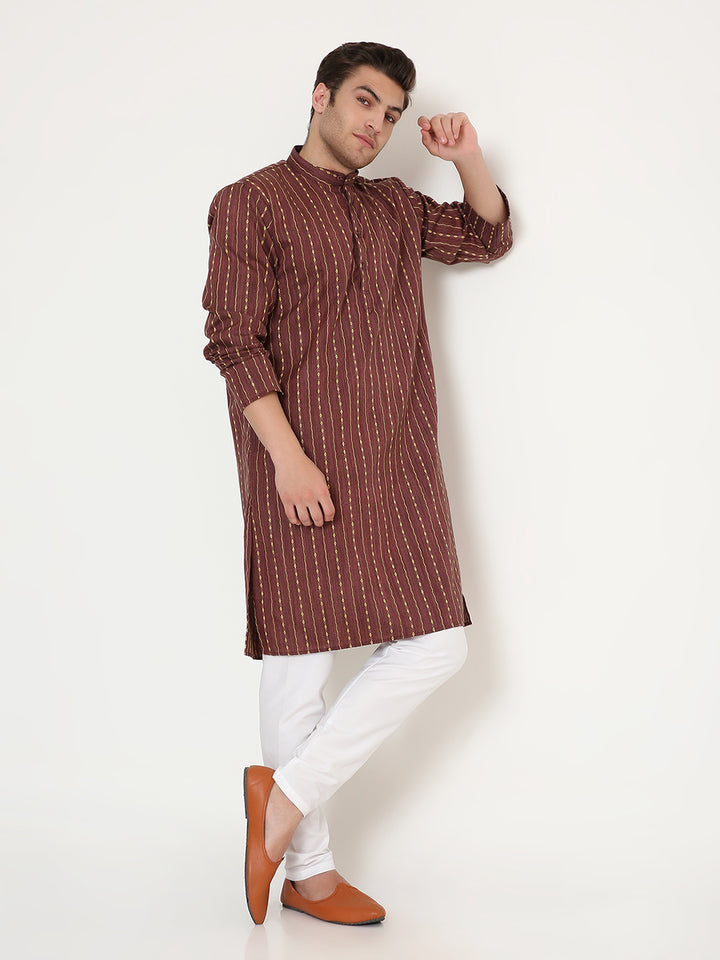 Stylish pose in maroon ethnic kurta set with golden detailing, highlighting its versatile design for events or everyday ethnic wear.