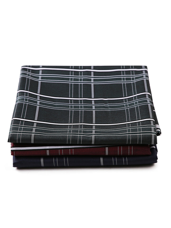 Stacked unstitched PolyBlend checkered shirt fabrics in green, navy, and maroon. Perfect for personalized shirt tailoring.