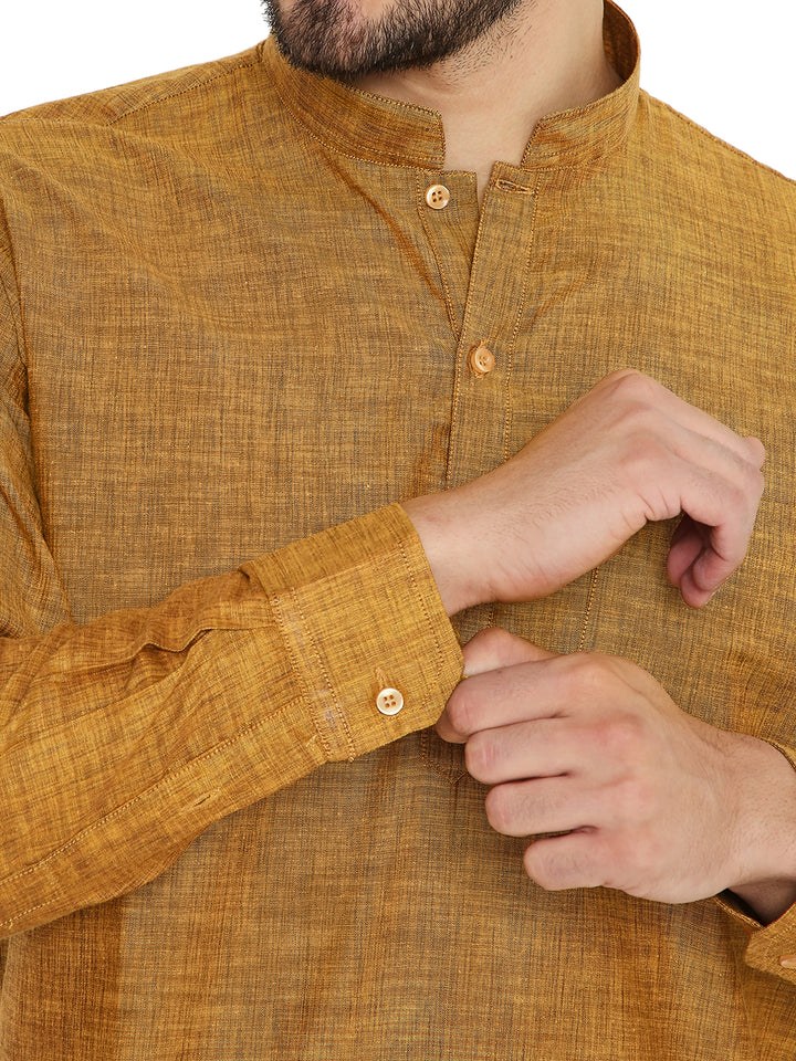 Close-up of yellow linen kurta sleeve and button detail, emphasizing fine craftsmanship and breathable summer fabric.