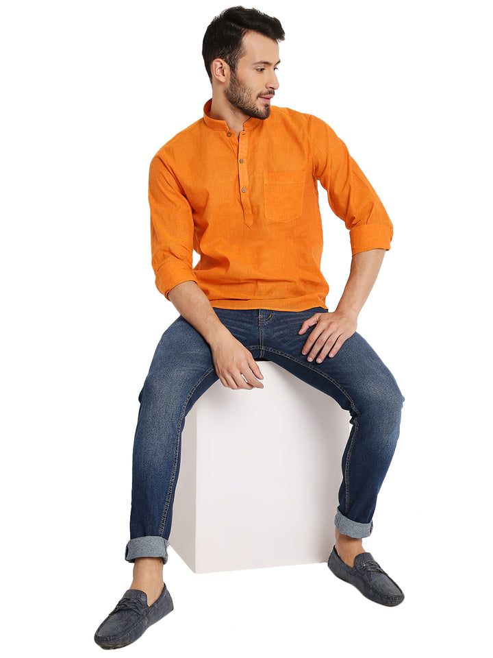 Model seated wearing Handloom Kurta - Cotton Orange, styled with jeans for a modern twist on traditional summer attire.