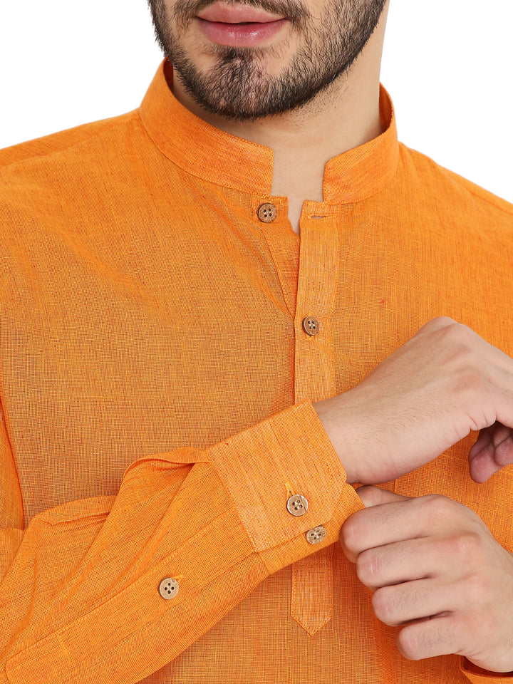 Close-up of orange Handloom Cotton Kurta showing wooden buttons and fine weave texture, highlighting craftsmanship and detail.