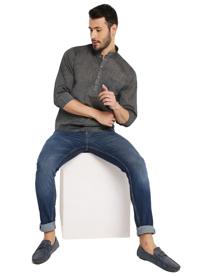 Model seated wearing Black Cotton Kurta - Comfortable Fit | Lightweight, Breathable paired with jeans, showcasing versatile ethnic fusion look.