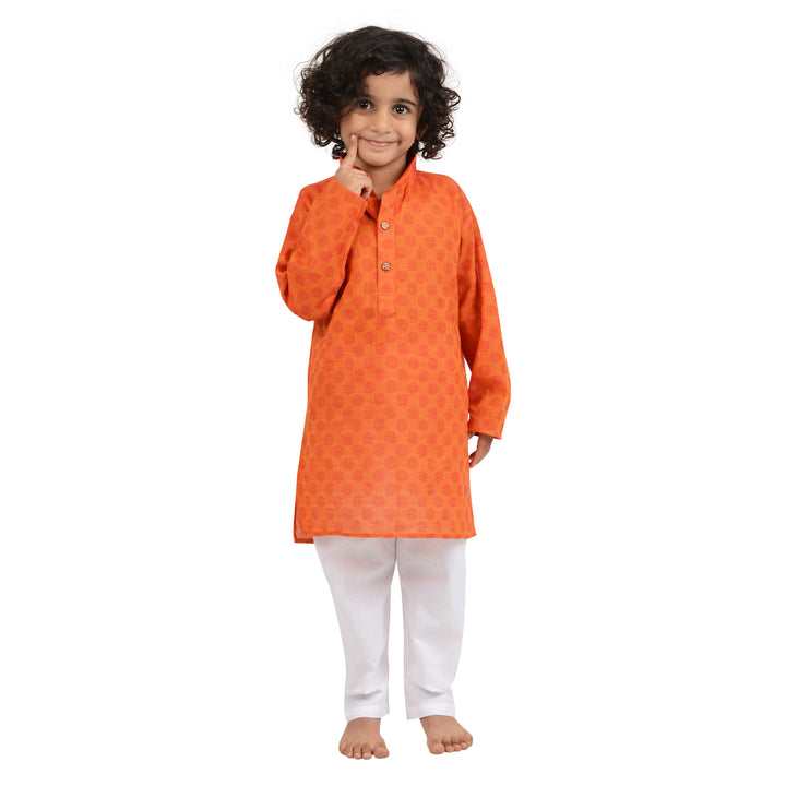Smiling boy wearing Maharaja Handloom Cotton Kurta in Dark Orange with white pyjama, combining comfort and festive elegance.