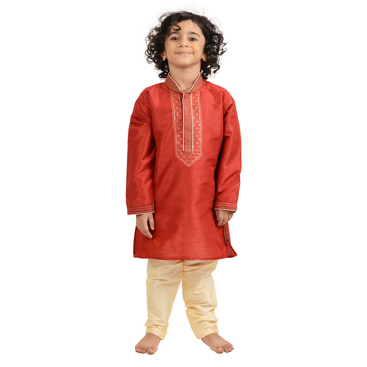 Kids Gold Kurta Set in red art silk with gold embroidery, perfect for weddings and festive occasions. Traditional boys kurta set with cream churidar.