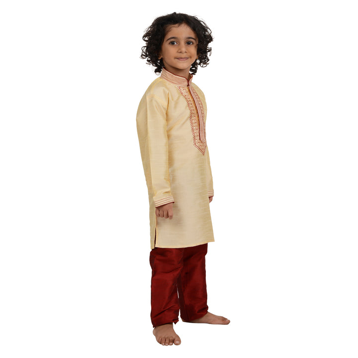 Angled side pose of boy wearing Art Silk Kurta - Kids Gold Kurta Set, ideal for traditional and ceremonial occasions.