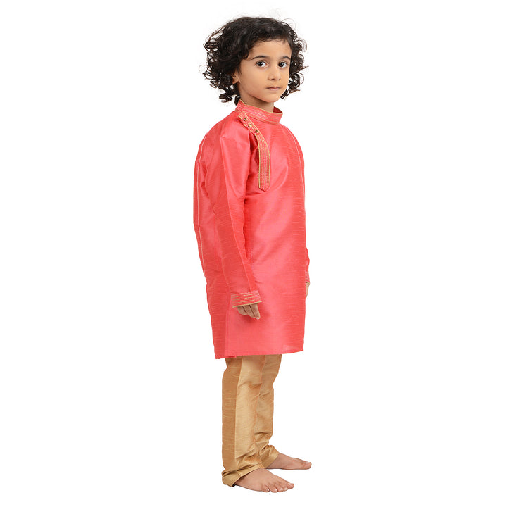 Kids traditional Art Silk Pink Kurta with side buttons, shown from side angle, paired with beige churidar for festive wear.