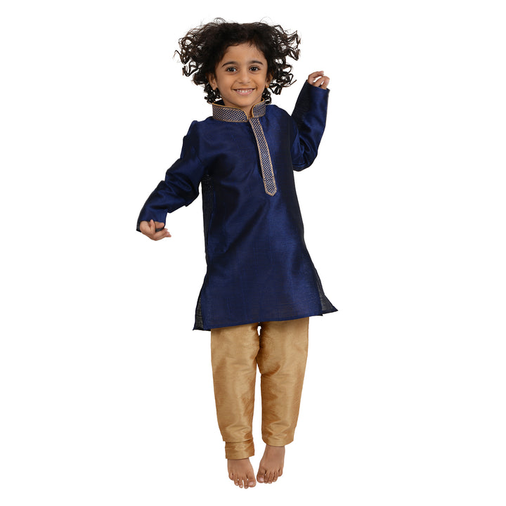Playful pose in Kids Gold Kurta Set with blue embroidered kurta and gold pants, ideal for ethnic celebrations and joyful moments.