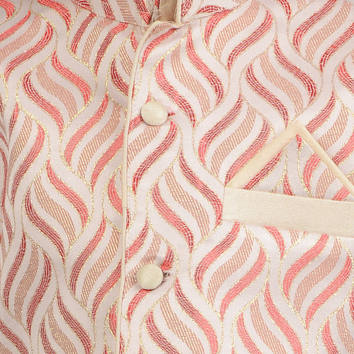 Close-up of red embroidered jacket on cream kurta, featuring wave pattern stitching and button details for premium boys ethnic wear.