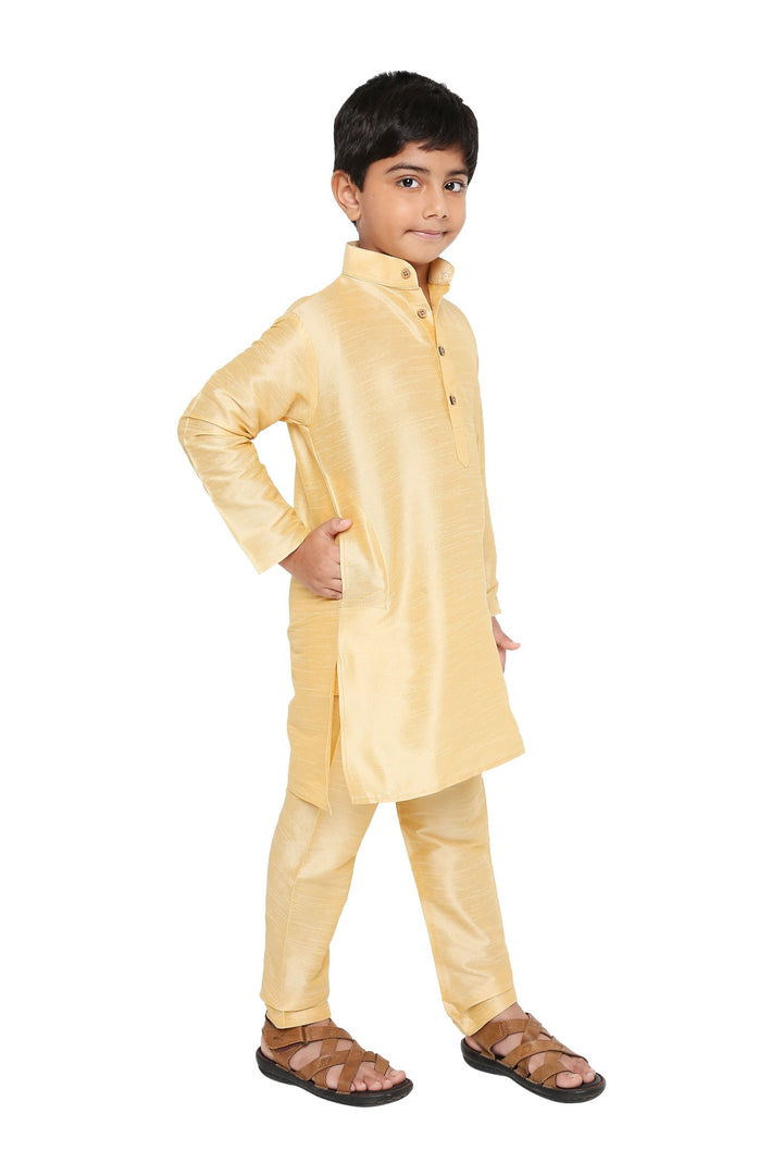 Side view of boy wearing Maharaja Kids Kurta Pyjama Set in beige, highlighting the elegant traditional fit and comfortable fabric.