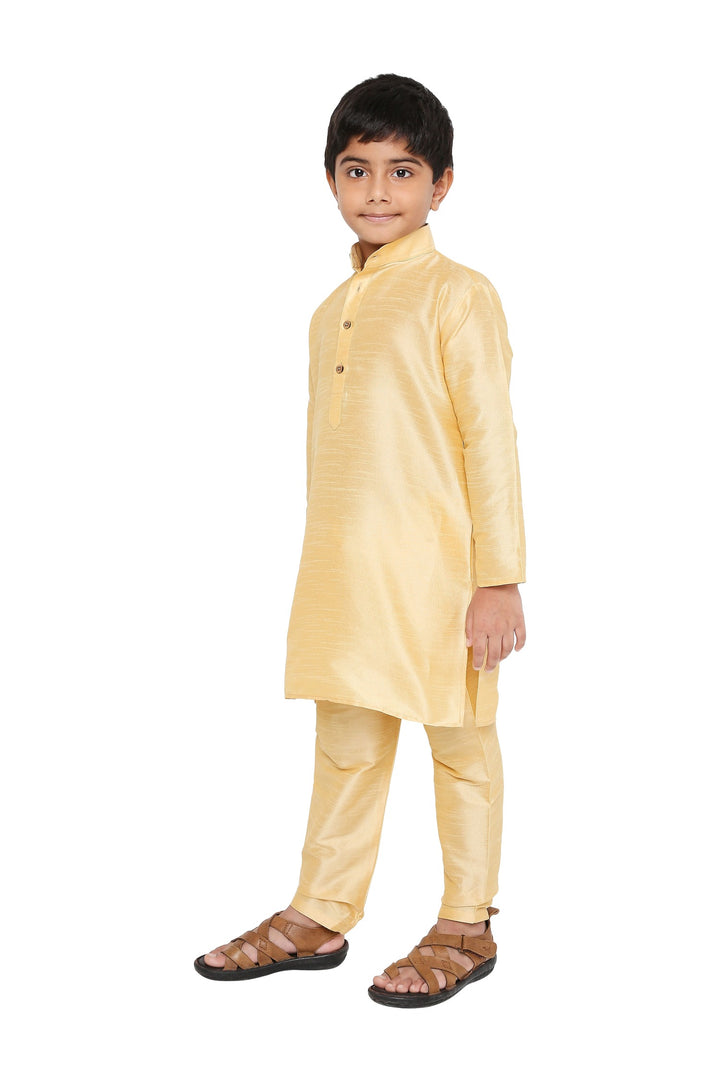 Angled front view of beige Banaras art silk kurta pyjama for boys, part of the Maharaja Kids Kurta Pyjama Set collection.