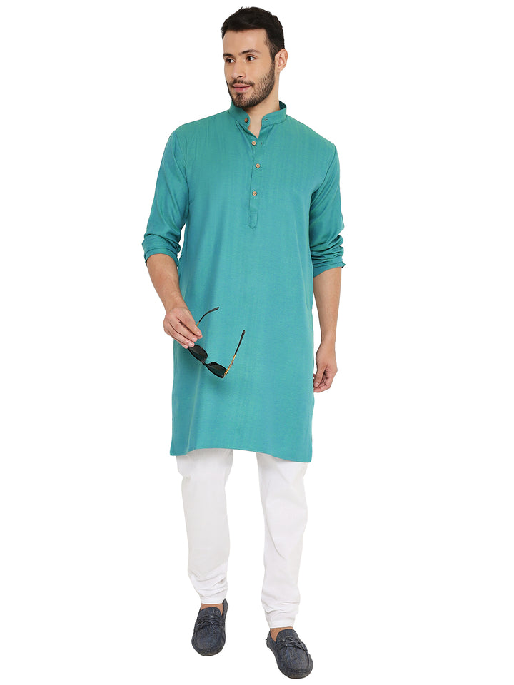 Green Linen Kurta paired with white bottoms, styled for a relaxed yet elegant look, ideal for casual gatherings.
