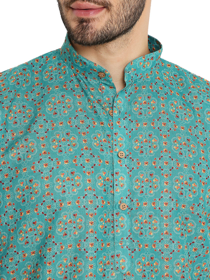 Close-up of green linen kurta collar and wooden buttons, featuring intricate traditional print and fine fabric texture.