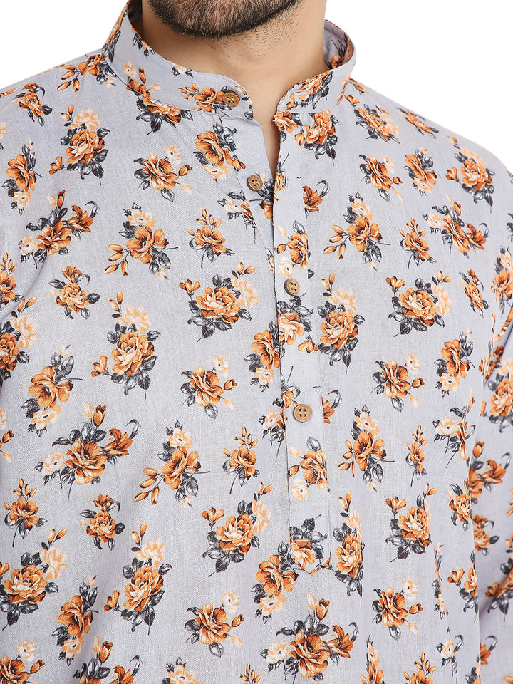 Close-up of floral print linen kurta in light grey, highlighting wooden buttons and intricate orange floral detailing.