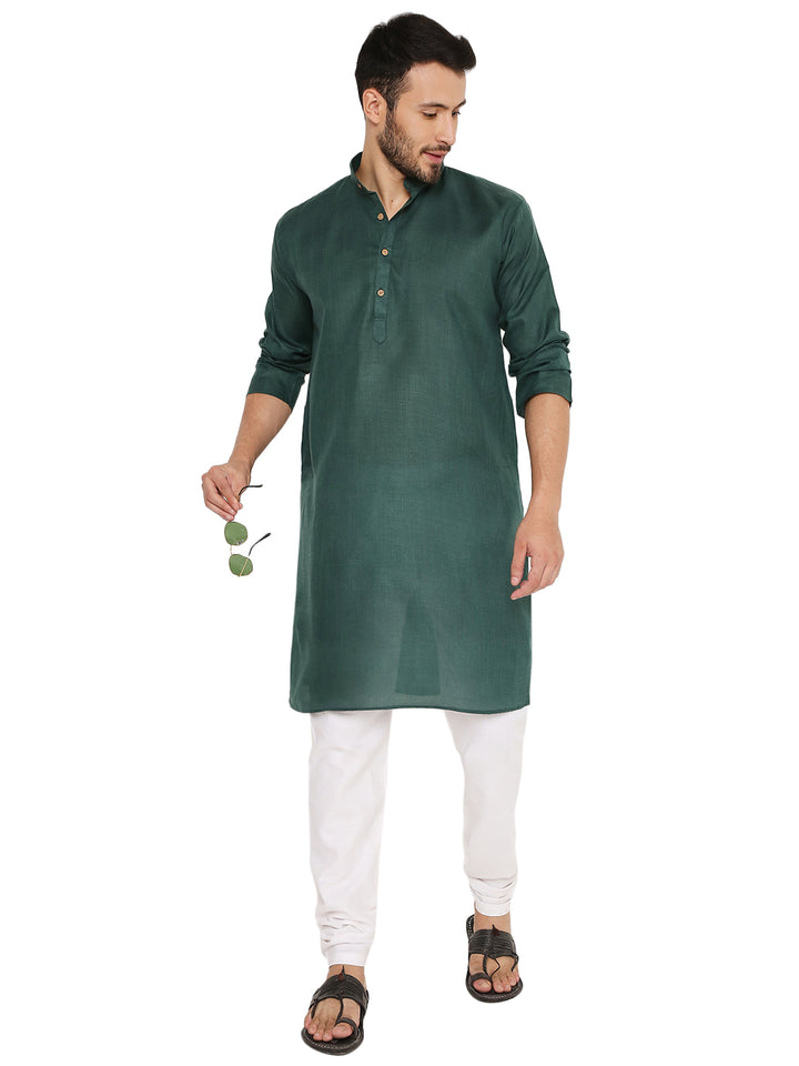 Stylish green Magic Cotton Kurta with rolled-up sleeves, worn with white churidar, offering a modern twist to ethnic wear.
