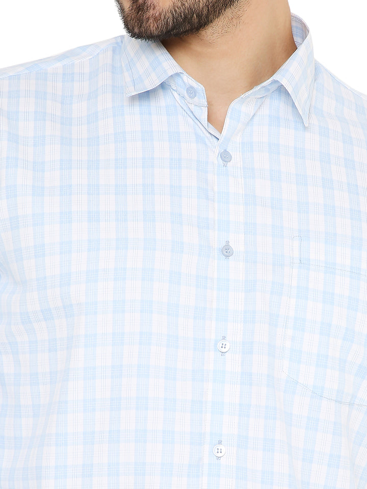 Close-up of Slim Fit Shirt - Light Blue showing fine checkered pattern, front pocket, and button details for a refined finish.