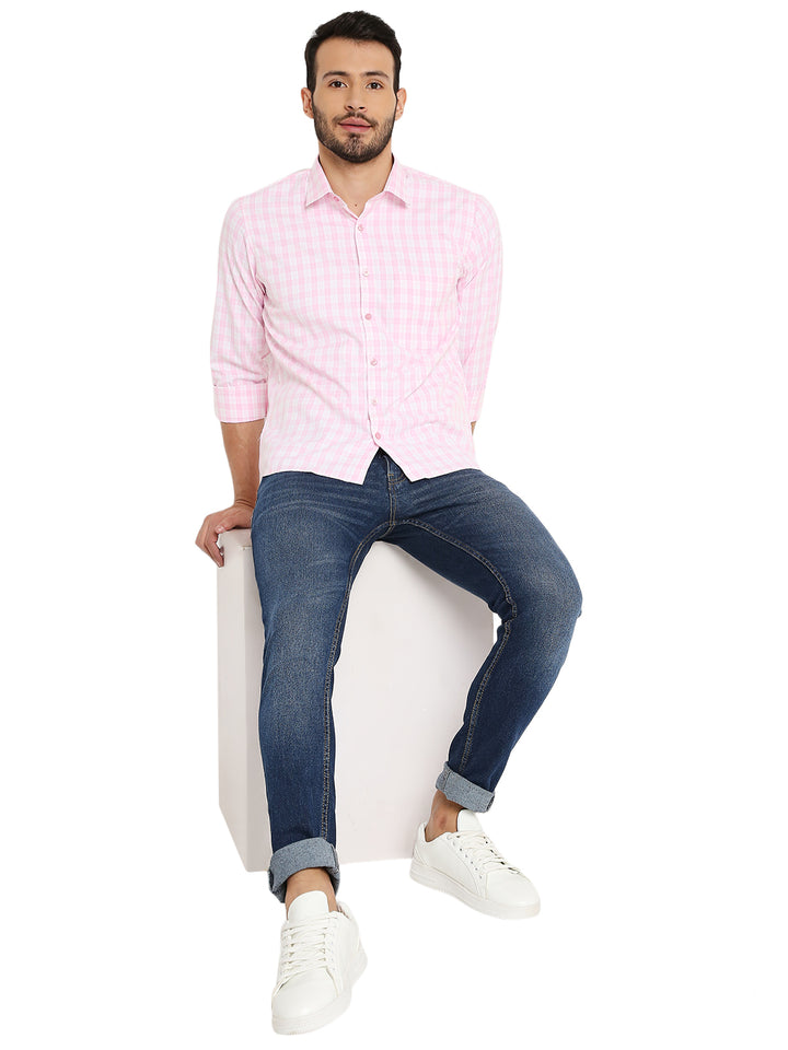 Model wearing Light Pink Slim Fit Shirt with small checks, paired with jeans and white sneakers for a smart-casual outfit.