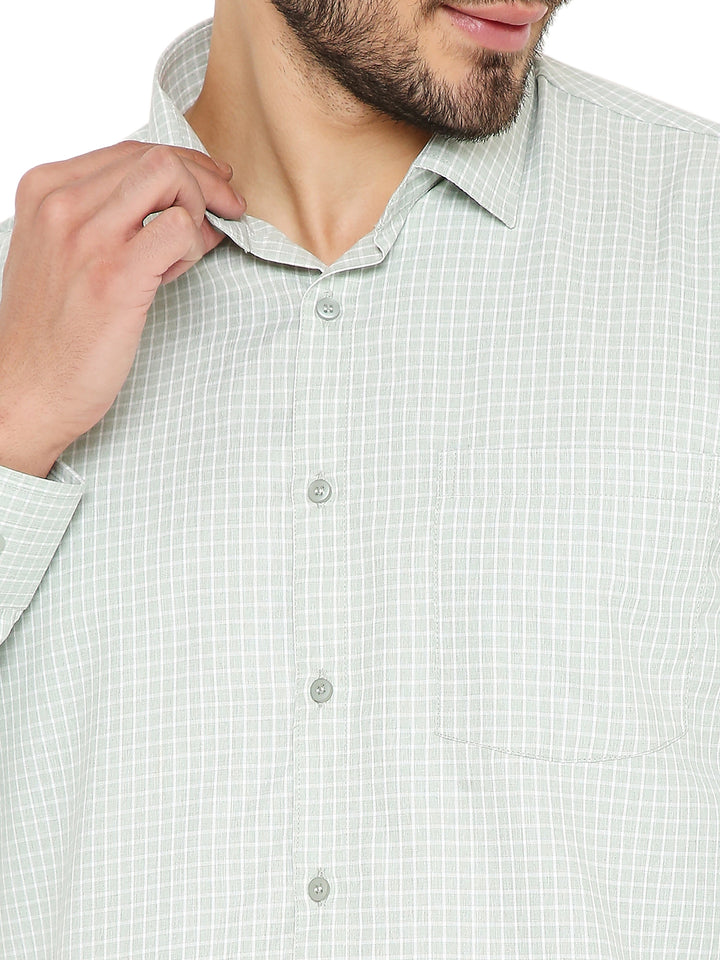 Close-up of green slim fit shirt with small checks, showing fine fabric texture, front pocket, and button details for refined styling.