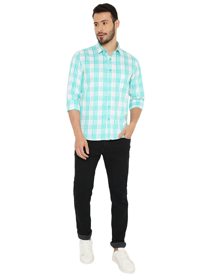 Full body view of man wearing green slim fit checkered shirt paired with black jeans and white sneakers, perfect for casual outings.