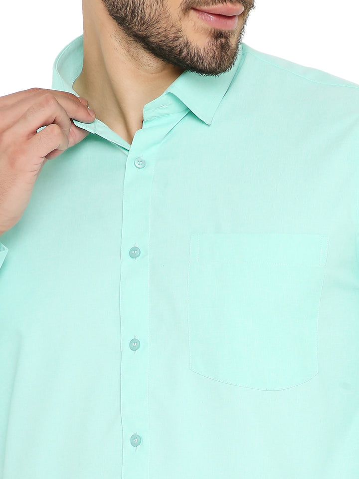 Close-up of bright green slim fit shirt highlighting soft fabric, front pocket, and button details. Easy-care and made in India.